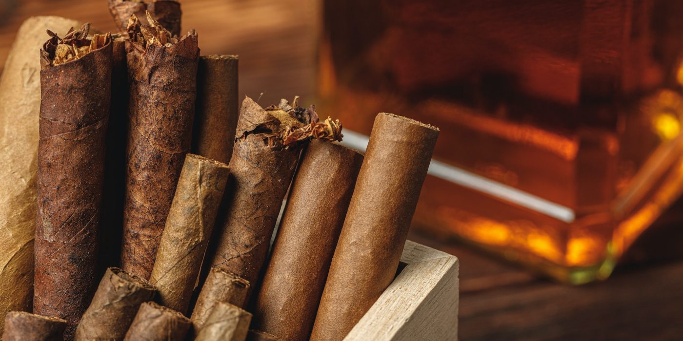 Pile of new cigars close up on wooden table